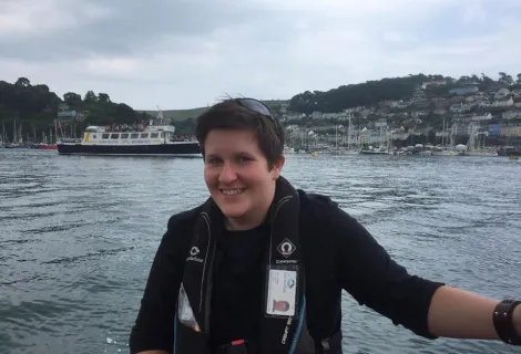 Smiling Jayne with large body of water in background and hills in distance