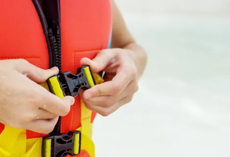 Close up of an individual fastening their lifejacket