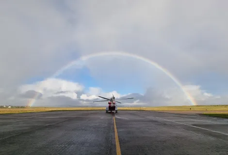 Rainbow over coastguard helicopter on Stornoway runway