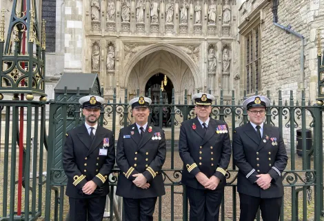 Four coastguards in dress uniform outside Westminster Abbey for remembrance events