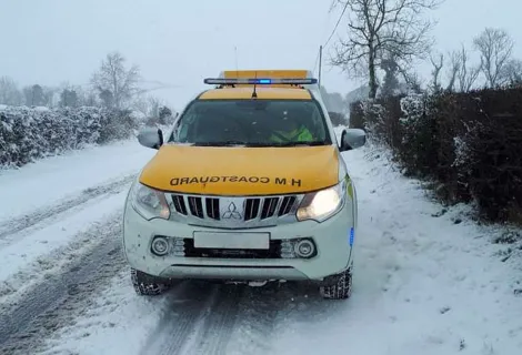 A Coastguard rescue vehicle driving in snowy conditions