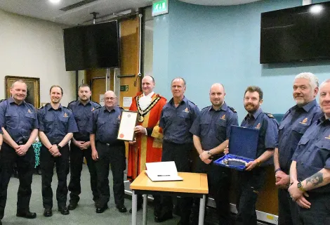 Hartlepool Coastguard Rescue Team and Ceremonial Mayor of Hartlepool Shane Moore stand for a photo, displaying the Honorary Freedom of the Borough