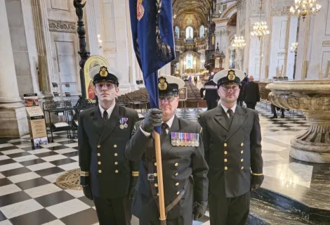 From left standing to attention at St Paul's Cathedral are Dan Foster, Kevin Moran holding the HM Coastguard colours, and George Belcher