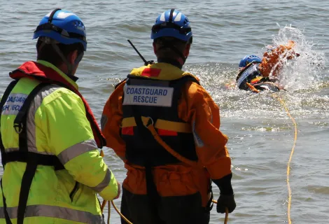 Coastguard rescue officers practice a water rescue