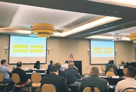 A woman gives a presentation to an audience at the SAR workshop in Miami