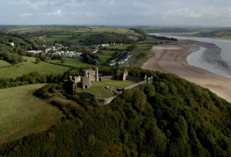 Aerial view of a coastal estuary with sand and a castle