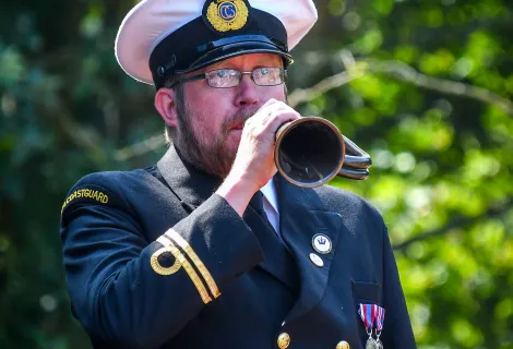 Senior Maritime Operations Officer Joel Harding bugles for a Remembrance Day service