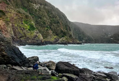 The craggy outcrop of Lee Beach is seen with tide crashing against the rocks and no obvious sign of exit 