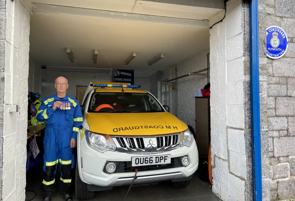 Keith poses with his service medals alongside the current, electric response vehicle in the station he has called 'home' for 56-years