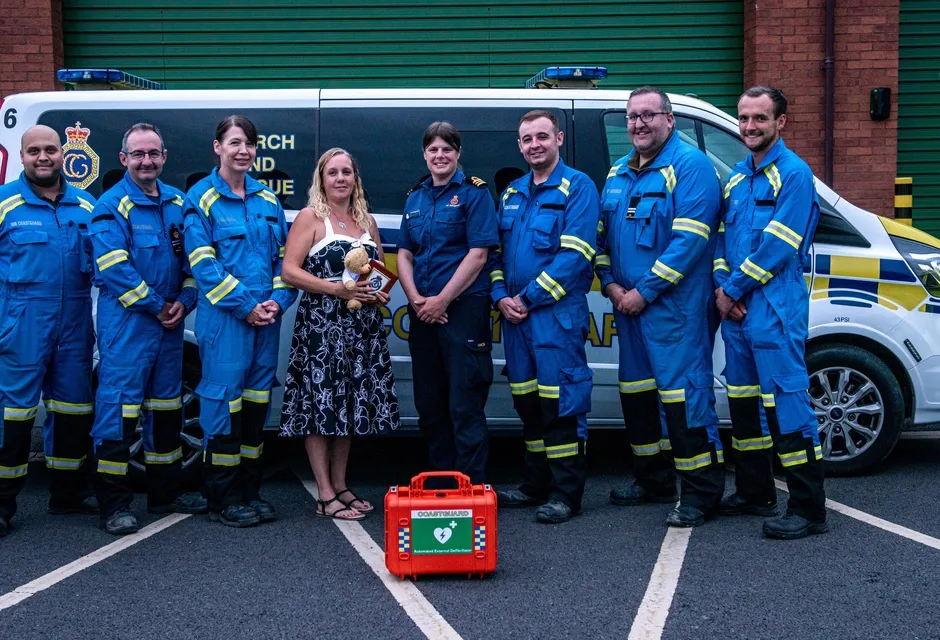 Donna with one of her children, alongside HM Coastguard and ambulance staff who worked together to save her life. Credit: Yorkshire Ambulance Service