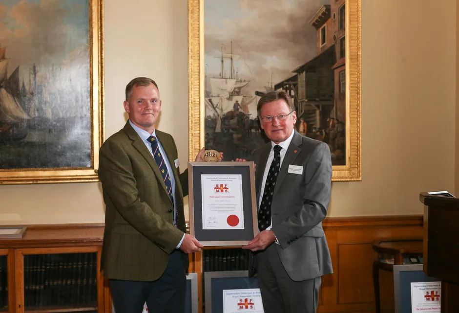 The 2022 Individual Commendation recipient at the Shipwrecked Mariners' Society annual Skill & Gallantry Awards - Mark ‘Spike’ Hughes, presented by Captain Ian McNaught, Deputy Master of Trinity House