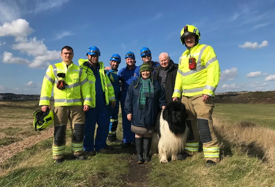 Max the Newfoundland dog with his owners and rescuers.