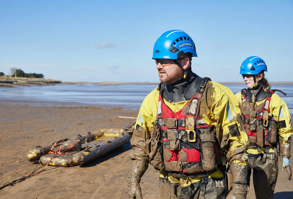 Two members of a coastguard mud rescue team 