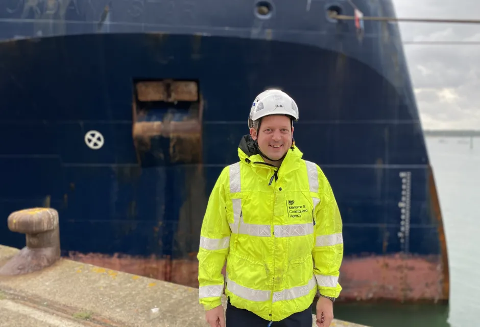 A picture of Survey and Inspection Technical Manager (Southampton) Chris D'Alcorn, stood in front of a vessel in S&I kit - Maritime Safety Week 2023