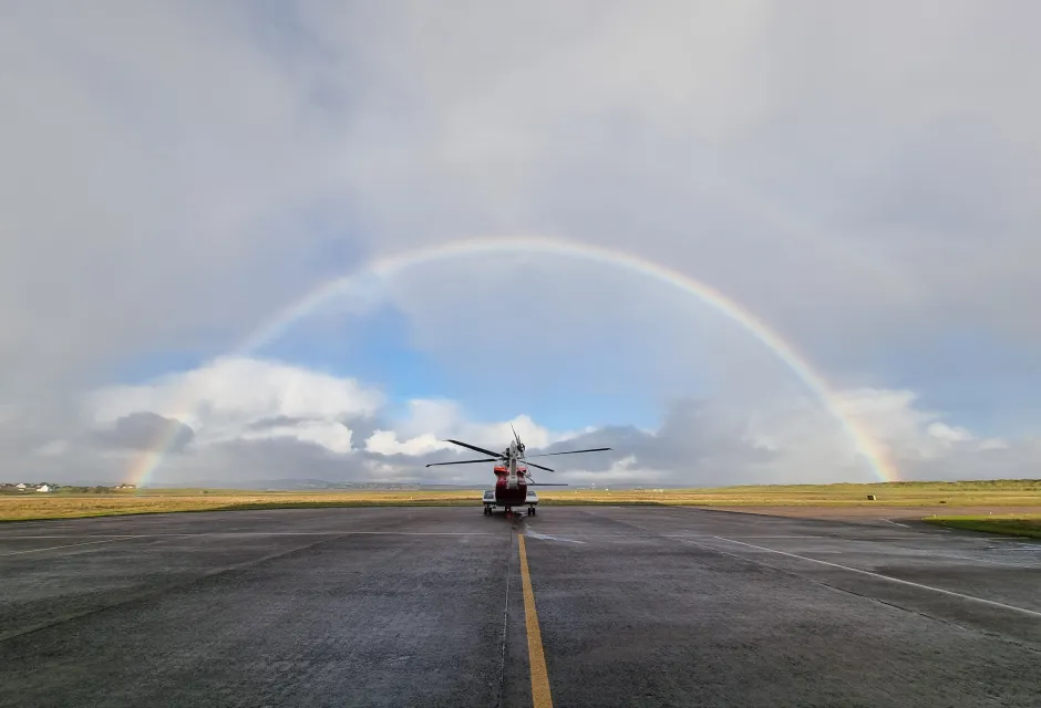 Rainbow over coastguard helicopter on Stornoway runway