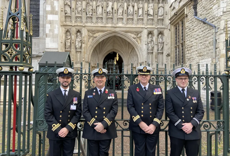 Four coastguards in dress uniform outside Westminster Abbey for remembrance events