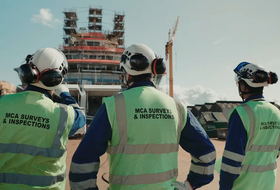 A three-person survey and inspection team at work on a vessel