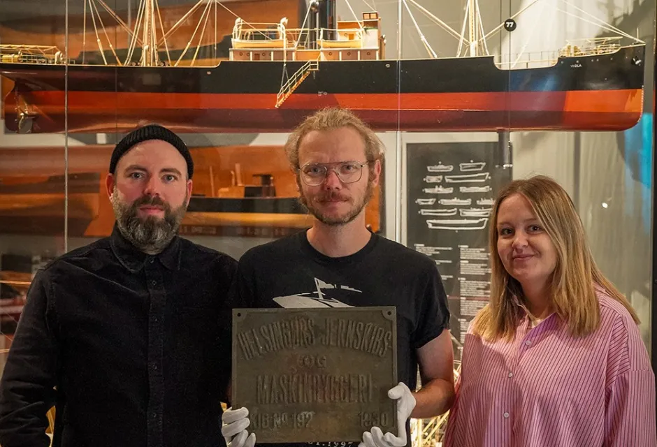 From left are Curators Jannik Hartrup and Curator Thorbjorn Thaarup, and Museum Assistant Mette Ebbesen in front of a model of the SS Viola, sister ship to the SS Birgitte