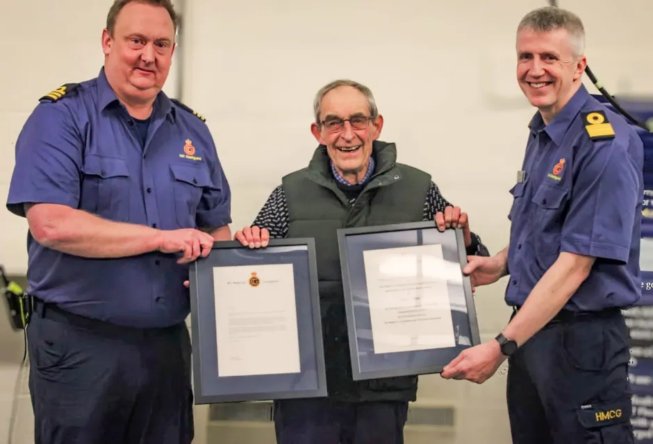 Paul 'Bud' White (centre) is presented with certificates by Divisional Commander Matt Pavitt (left) and Assistant Chief Coastguard Channel Operations John Craig (right)
