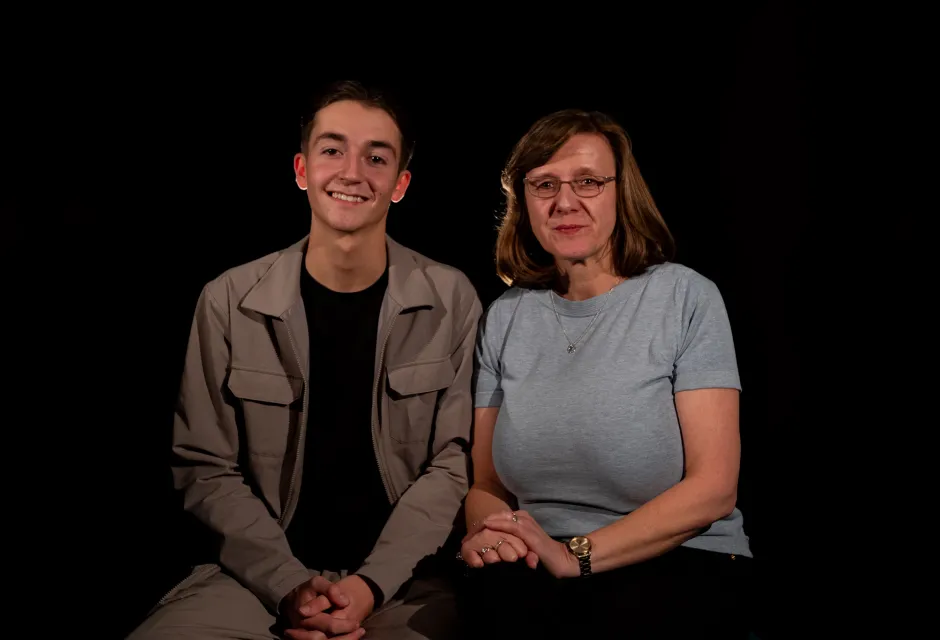 Joe Green and Vanessa Abbess sat next to one another against a plain, dark background