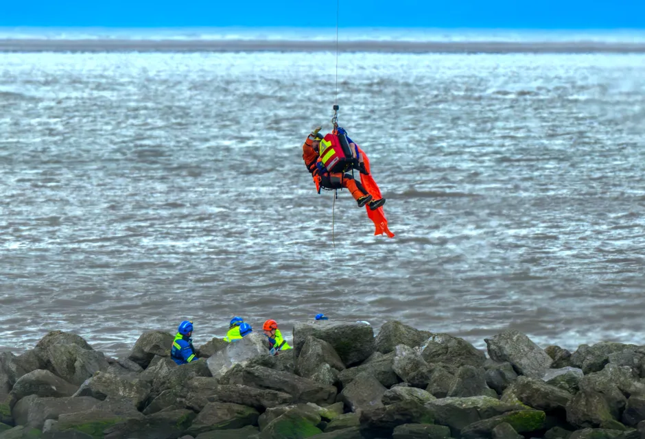 A Coastguard Winch Paramedic lifts a casualty from Leasowe Bay, Wirral